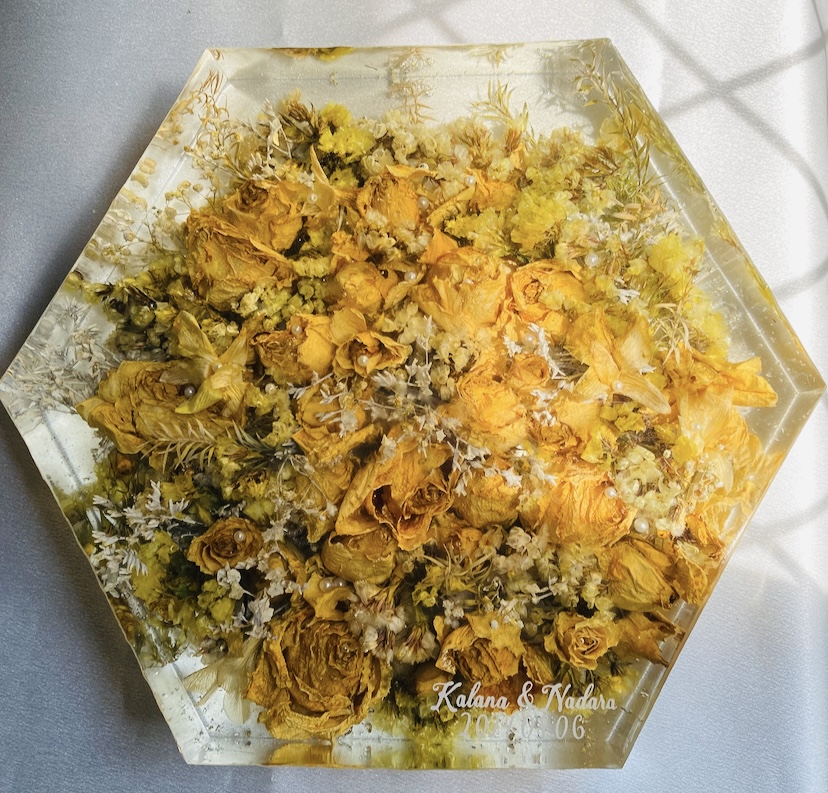 A preserved wedding bouquet set in a resin keepsake block