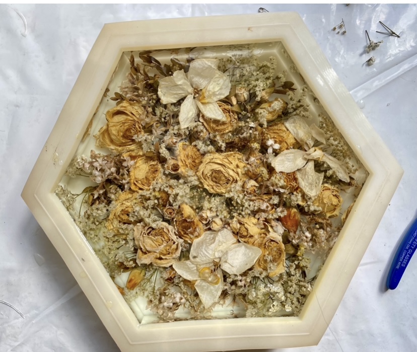Dried flowers preserved inside a hexagon resin tray